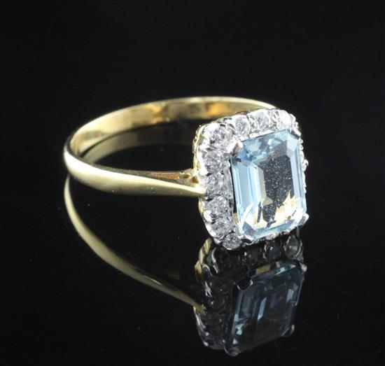 An 18ct gold, aquamarine and diamond cluster ring, size P.